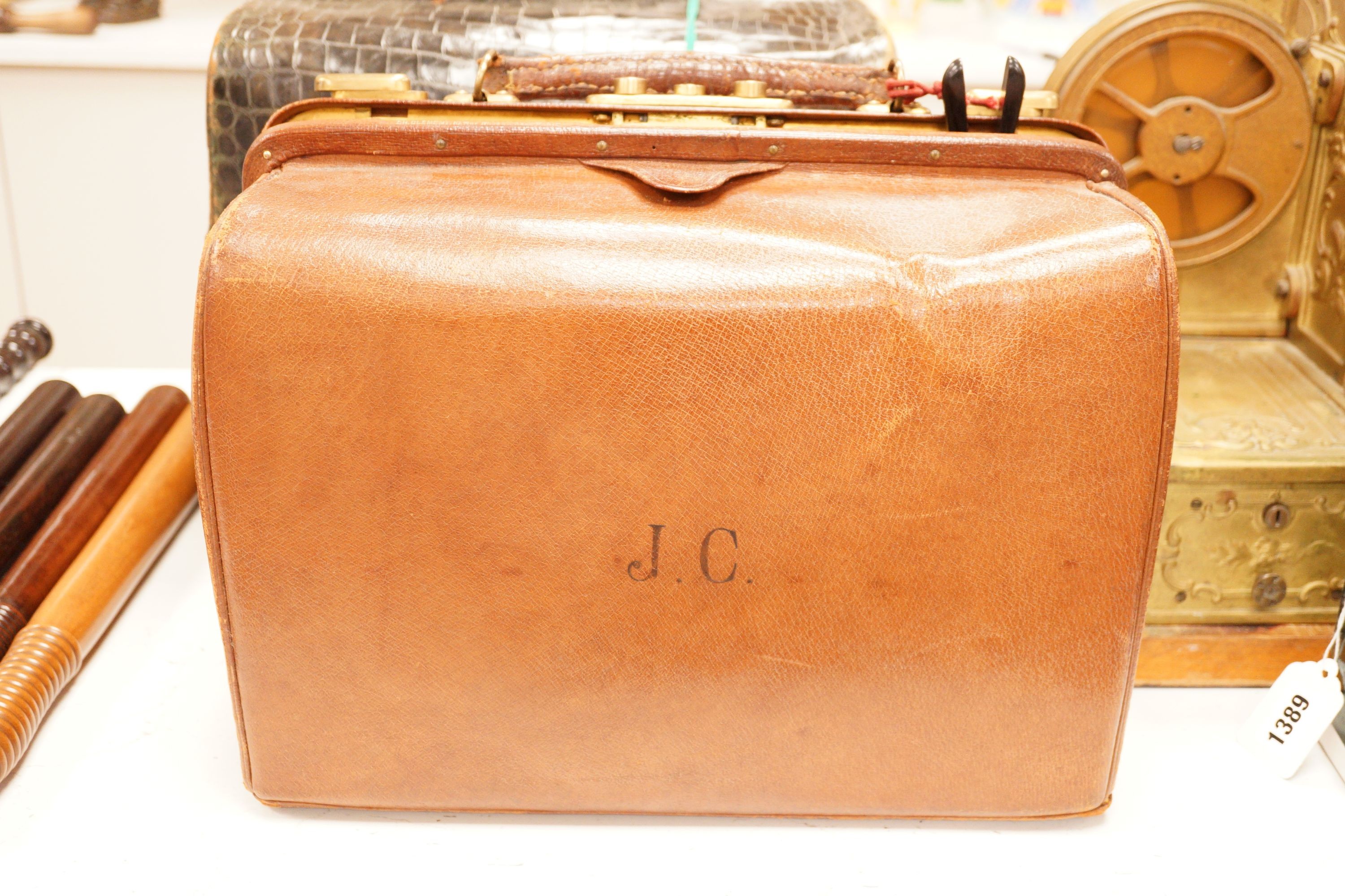 A Drew & Sons Leadenhall St. faux green crocodile gentleman’s vanity case including silver mounted glass jars etc. and a leather gentleman’s case